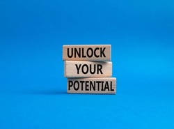 Unlock your Potential symbol. Wooden blocks with words Unlock your Potential. Beautiful blue background. Business and Unlock your Potential concept. Copy space.