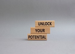 Unlock your Potential symbol. Wooden blocks with words Unlock your Potential. Beautiful grey background. Business and Unlock your Potential concept. Copy space.