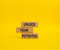 Unlock your Potential symbol. Wooden blocks with words Unlock your Potential. Beautiful yellow background. Business and Unlock your Potential concept. Copy space.