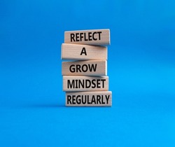 Refclect a grow mindset regularly symbol. Wooden blocks with words Refclect a grow mindset regularly. Beautiful blue background. Business and Refclect a grow mindset regularly concept. Copy space.