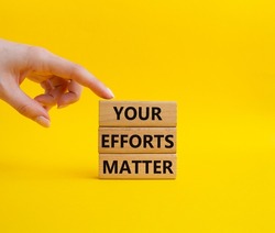Your Effort Matter symbol. Wooden blocks with words Your Effort Matter. Beautiful yellow background. Businessman hand. Business and Your Effort Matter concept. Copy space.