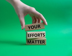 Your Efforts Matter symbol. Wooden blocks with words Your Efforts Matter. Beautiful green background. Businessman hand. Business and Your Efforts Matter concept. Copy space.