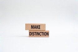 Make distinction symbol. Concept words make distinction on wooden blocks. Beautiful white background. Business and make distinction concept. Copy space.