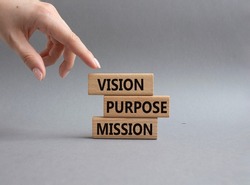 Vision Purpose Mission symbol. Concept word Vision Purpose Mission on wooden blocks. Beautiful grey background. Businessman hand. Business and Vision Purpose Mission concept. Copy space.
