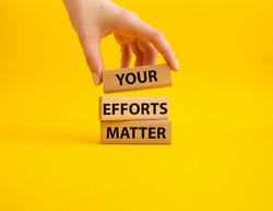 Your Efforts Matter symbol. Wooden blocks with words Your Efforts Matter. Beautiful yellow background. Businessman hand. Business and Your Efforts Matter concept. Copy space.