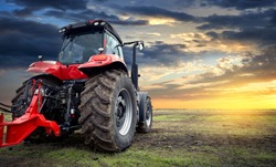 Tractor working on the farm at sunset, a modern agricultural transport, a farmer working in the field, modern tractor closeup