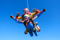Skydiving. Tandem jump. Passenger is having fun.