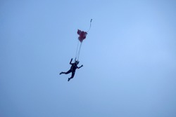 The finish of freefall. A parachute is beginning to deployed.