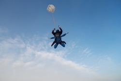 Skydiving.Tandem jump. An instructor and a passenger are in the sky.