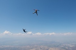Skydiving.Two skydivers are flyng in the sky.