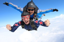 Skydiving. Tandem passenger is very happy.