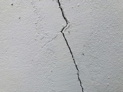 wall cracks cracks erosion erosion of the wall damaged  wall surface peeling off damaged white wall background.