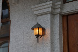 A Lit Lamp on the Porch Wall