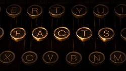 Photograph of a vintage typewriter keyboard with scratched chrome keys. In the center, shining, brightly lit keys form 