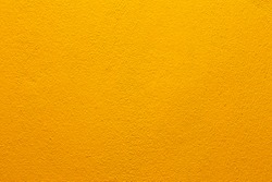 Colorful concrete wall, bright yellow vintage style of cement background paint with small texture details.