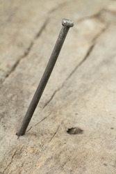 Close-ul of bent nail into a wooden wall 