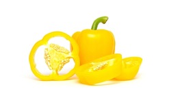 Whole and sliced yellow bell pepper or paprika isolated on white background.