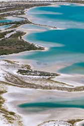 An overhead view of Tiger Tail Beach as the tide wanes from the shore.