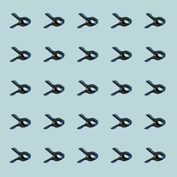 Pattern of black multipurpose clamps with blue grips. Vertical orientation. Blue background.