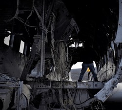 Wrecked US navy plane in Solheimasandur. Old broken cables and person standing in darkness representing the dark time that crew of this unfortunate plane had faced during plane crash
