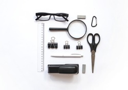 Working place composition with Pen, glasses , magnifier, scissors, line, stapler and other office decoration  on  white background, top view, flat lay