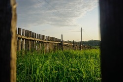 Old fence in a Russian village at sunset. Ufa, Bashkiria