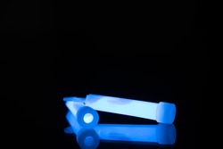 Blue glowsticks on a reflective surface