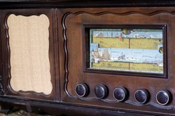 Vintage radio front with buttons and dial on wooden body