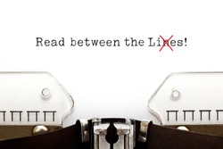 Text Read Between The Lies typed on vintage typewriter. The usually used word in the original idiom Lines is changed to Lies.