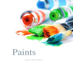 Colorful paints and artist brushes isolated over white