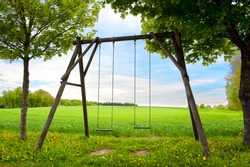 Lone swing seat in a summer field