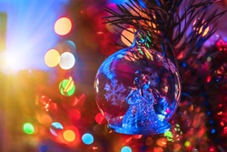 Christmas glass toy angel for Christmas tree closeup. Christmas colorful background. Christmas tree. Festive lights