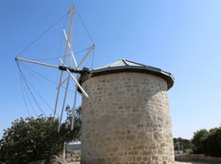 Old Greek Windmill with Trees and Blue Sky in Alacati, Izmir, Turkey