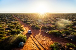 Australia, red sand unpaved road and 4x4 at sunset, Francoise Peron, Shark Bay