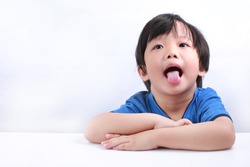 Funny expression of a little Asian boy isolated on white background
