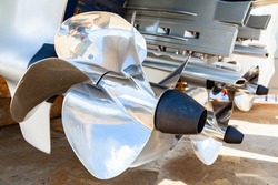 Motor propellers for motor yachts and boats close-up. The motors are mounted at the stern of the motor boat. Repair a boat in a dry dock.