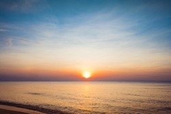 Beautiful golden sunset with blue sky over the horizon on the beach, Thailand. The coastal scene along the coast over the horizon on the ocean background. Tropical landscape summer sea concept.