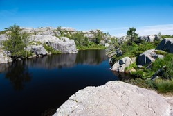 Clear mirror-like mountain lake in the area around Pulpit Rock (Preikestolen)