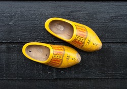 traditional dutch wooden shoes hanging at a wall