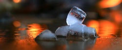 Ice melting  with flames on background.