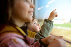 Children looking outside window train. Going on vacations and traveling by railway. High speed express train. Travel by railway on vacation. Kid in railroad car. Kids in rail way wagon. Happy family.