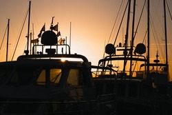 Silhouettes of boats during goldenhour in Anholt marina