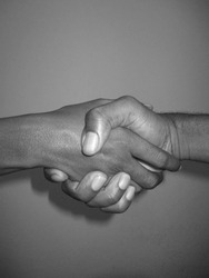 This is a black and white photo of a handshake. Add appeal to your visual creative work today!