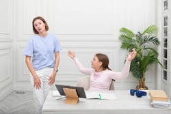 Mother angry with her daughter when she studies online at home	