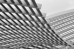 Close-up photo of technological metal grid structure. Abstract black and white background image on the subject of modern architecture, industry or technology.