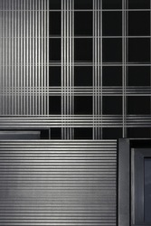 Steel grid structure resembling wall of industrial or office building. Architectural detail. Hi-tech material backgrond. Modern architecture. Checkered geometric pattern. Rectangles and parallel lines