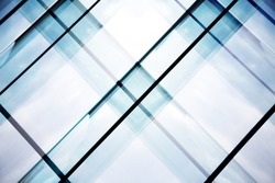 Reworked tilt photo of glass walls of office building. Abstract modern architecture background with geometric structure.