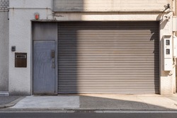Automatic white roller shutter doors on the ground floor of the house
