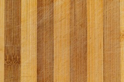 Used bamboo cutting board texture. Top macro view of bamboo cutting board with vertical lines