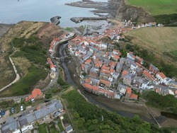 aerial view of Staithes seaside village and fishing port in the borough of Scarborough in North Yorkshire, England